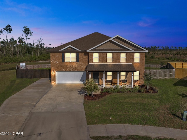 3946 Whitehead Blvd, Panama City, FL 32404 - traditional-style house with concrete driveway, fence, a yard, a garage, and brick siding