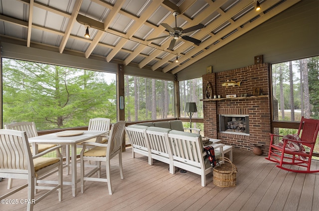 wooden deck featuring an outdoor living space with a fireplace, outdoor dining space, and ceiling fan