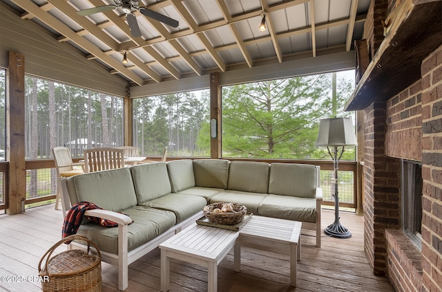 sunroom featuring beam ceiling, ceiling fan, and an outdoor hangout area