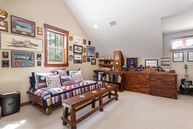 carpeted bedroom featuring vaulted ceiling and visible vents