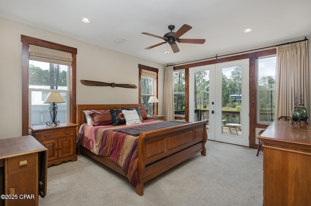 bedroom with multiple windows, visible vents, light colored carpet, and access to exterior