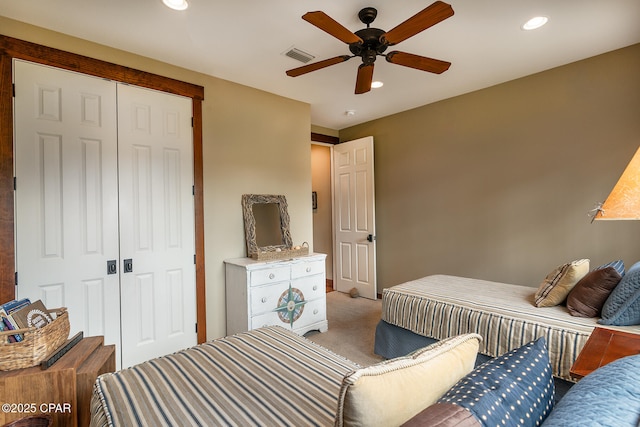 bedroom featuring a closet, ceiling fan, carpet flooring, visible vents, and recessed lighting