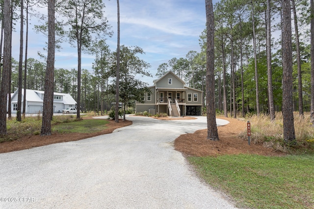 view of home's community featuring stairs and curved driveway