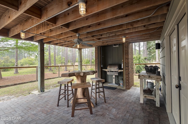 view of patio / terrace with outdoor dry bar, area for grilling, and fence