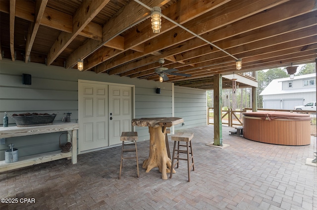 view of patio / terrace featuring outdoor dry bar, a hot tub, and ceiling fan
