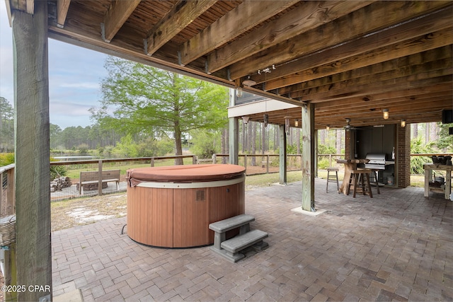 view of patio / terrace with a fenced backyard and a hot tub