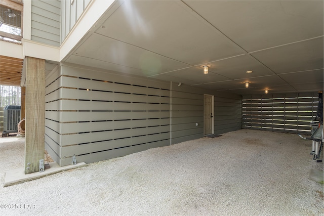 garage featuring a carport and central AC