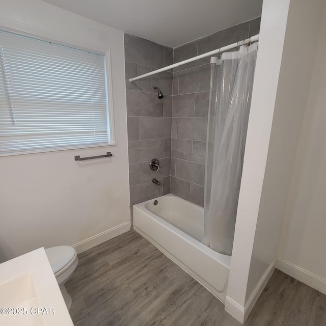 full bath featuring baseboards, shower / bath combo with shower curtain, wood finished floors, and toilet