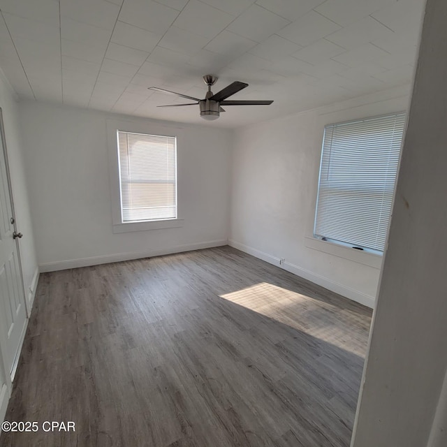 unfurnished bedroom with baseboards, a ceiling fan, and wood finished floors