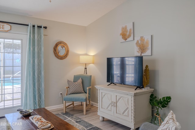 sitting room featuring light wood finished floors, baseboards, and plenty of natural light