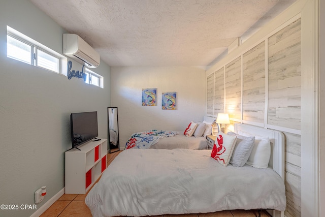 tiled bedroom with an AC wall unit and a textured ceiling