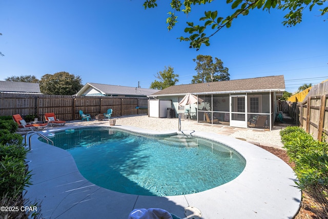 view of swimming pool featuring a fenced backyard, a fenced in pool, a patio, and a sunroom