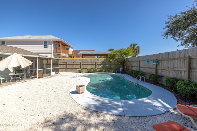 view of pool with a fenced in pool, a patio, a fenced backyard, and a sunroom