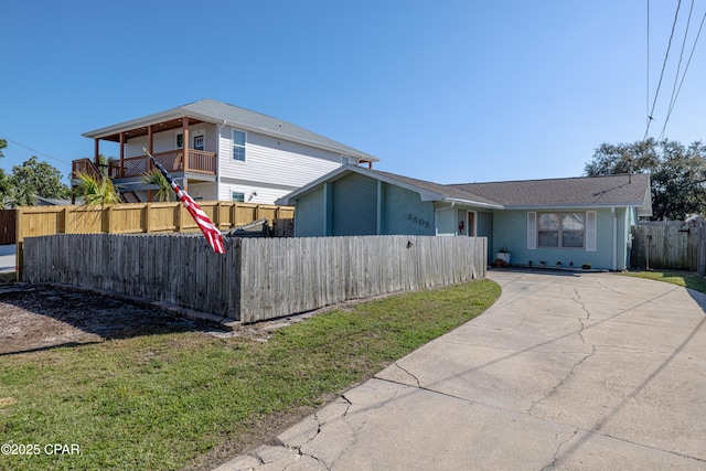 view of property exterior featuring driveway and fence
