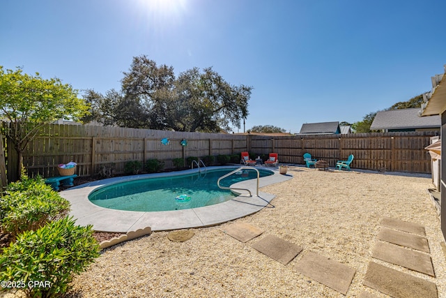 view of swimming pool featuring a fenced backyard, a fenced in pool, and a patio area