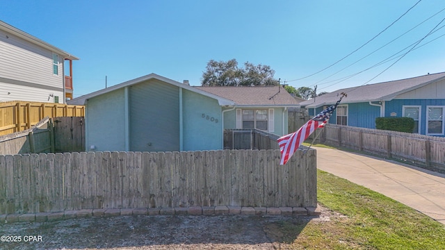 rear view of house with fence private yard and stucco siding