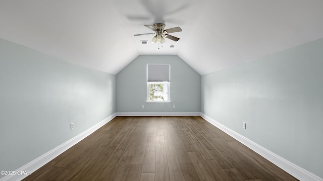 bonus room with lofted ceiling, a ceiling fan, dark wood-style floors, and baseboards