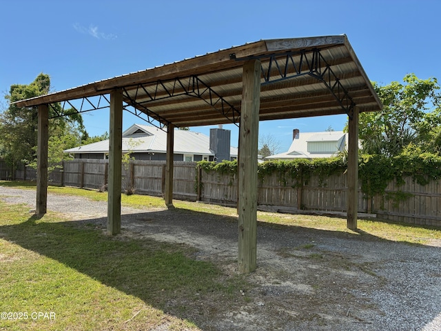 view of yard featuring a detached carport and fence