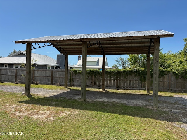 view of yard featuring a carport and fence