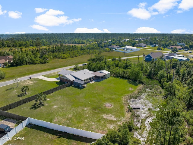 birds eye view of property with a forest view and a residential view