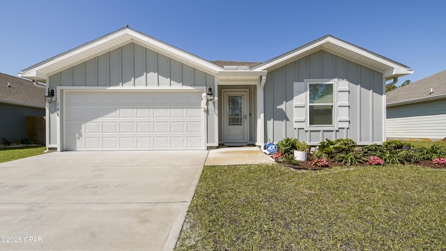 ranch-style home featuring board and batten siding, driveway, a front yard, and a garage