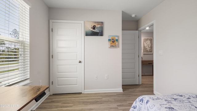 bedroom with light wood-style floors and baseboards