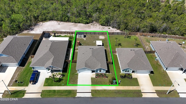 aerial view featuring a residential view and a wooded view