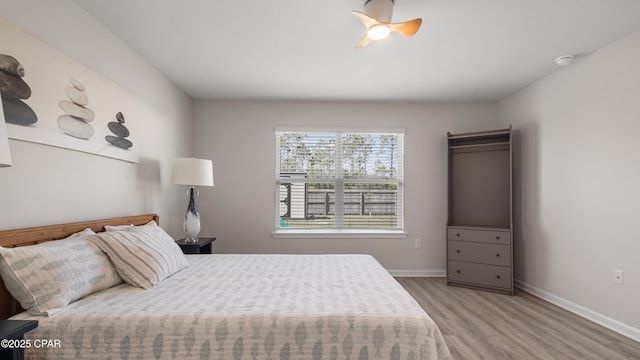 bedroom with baseboards and wood finished floors