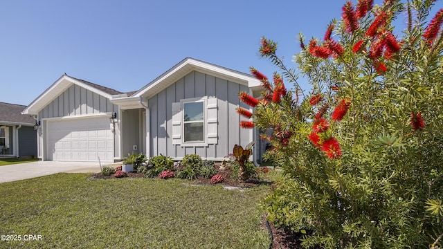 ranch-style home with board and batten siding, an attached garage, concrete driveway, and a front lawn