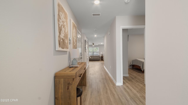 hallway with visible vents, recessed lighting, light wood-style flooring, and baseboards