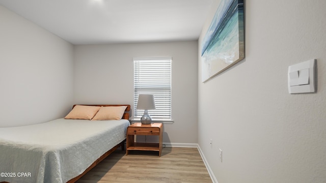 bedroom with baseboards and light wood-style flooring