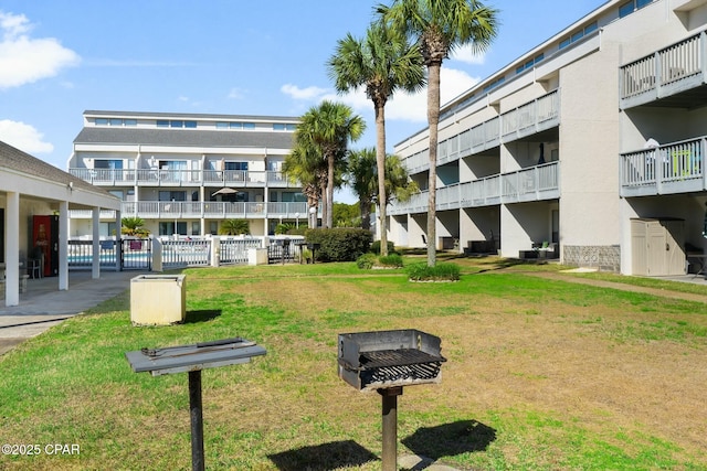 surrounding community featuring fence and a yard