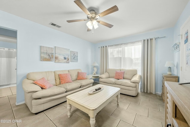 living area with a ceiling fan, visible vents, and light tile patterned flooring