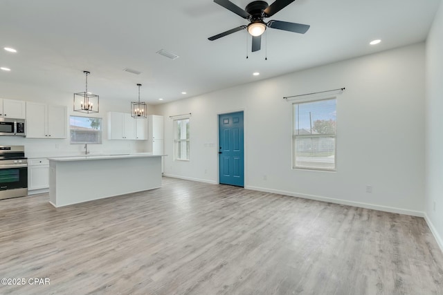 517 Kraft Ave, Panama City, FL 32401 - unfurnished living room with recessed lighting, plenty of natural light, and light wood finished floors