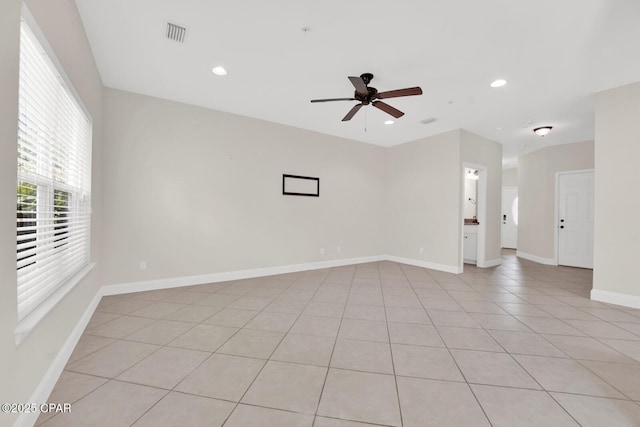 empty room featuring recessed lighting, visible vents, baseboards, and a ceiling fan