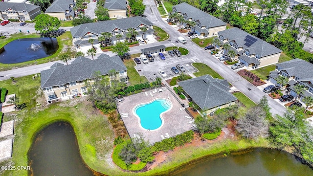 drone / aerial view with a residential view and a water view