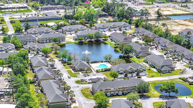 drone / aerial view with a water view and a residential view