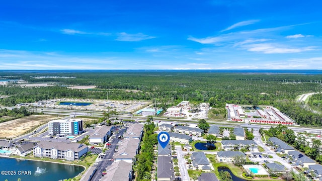 birds eye view of property with a water view and a view of trees