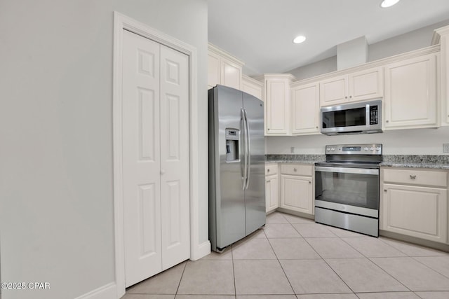 kitchen with appliances with stainless steel finishes, light tile patterned flooring, and recessed lighting