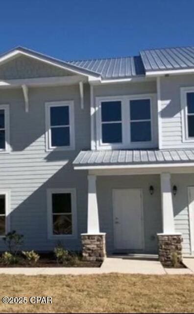view of front facade with metal roof and a standing seam roof