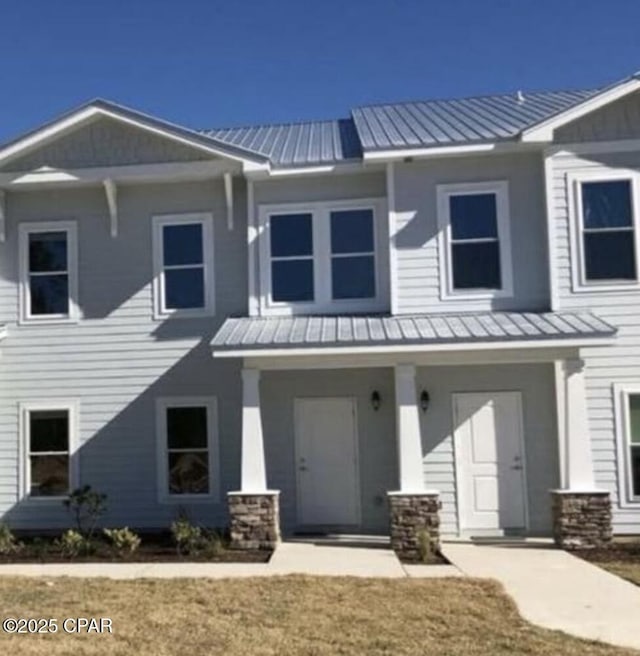 view of front of house featuring metal roof, a standing seam roof, and covered porch
