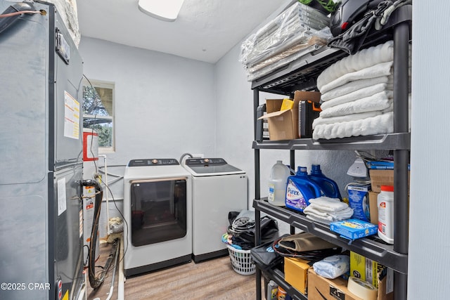 washroom featuring washer and clothes dryer, laundry area, and wood finished floors