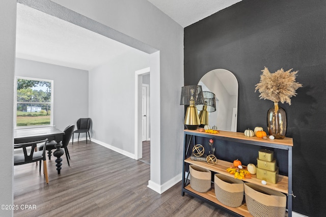 interior space with wood finished floors and baseboards