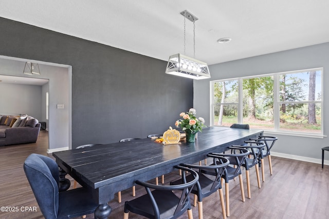 dining room with baseboards and wood finished floors