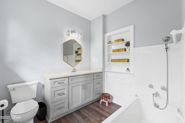 full bathroom with walk in shower, a bathing tub, toilet, vanity, and wood finished floors