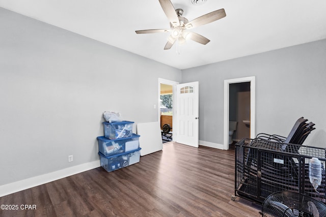 office area with wood finished floors, baseboards, a ceiling fan, and visible vents