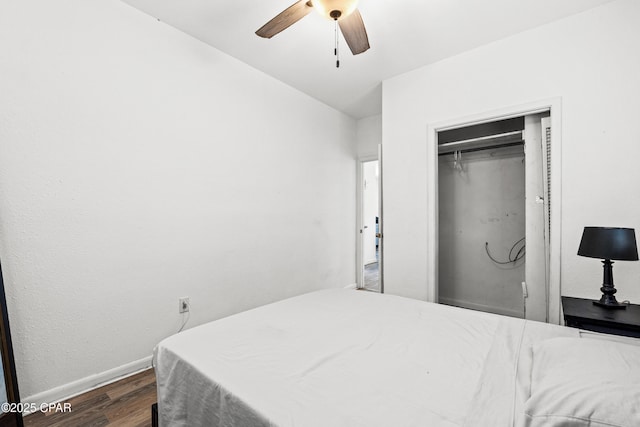 bedroom with a closet, baseboards, a ceiling fan, and dark wood-style floors