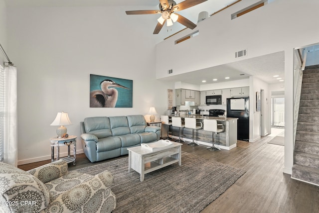 17670 Front Beach Rd Unit B8, Panama City Beach, FL 32413 - living room featuring dark wood finished floors, visible vents, baseboards, stairs, and ceiling fan