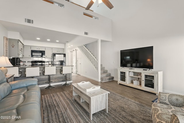 17670 Front Beach Rd Unit B8, Panama City Beach, FL 32413 - living area featuring dark wood-type flooring, visible vents, a ceiling fan, and stairs