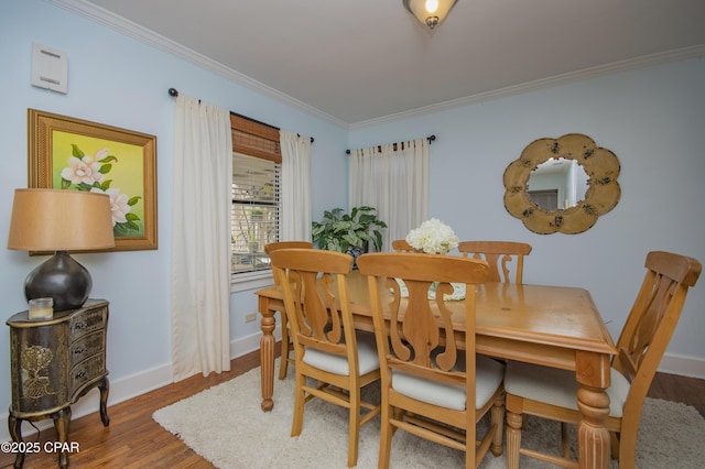 dining space with wood finished floors, baseboards, and ornamental molding